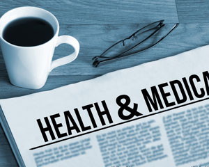 coffee, reading glasses, newspaper with heading: health and medicine