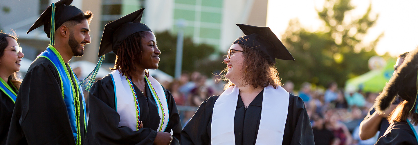 two graduates conversing