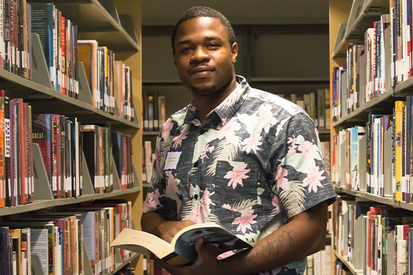 Library bookshelves with student in between