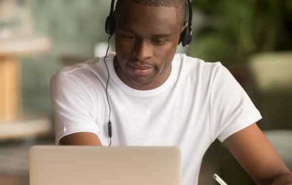 African American male student working on a laptop