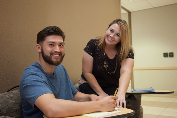 a student and counselor smiling