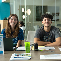 Greeting students at a table with school supplies