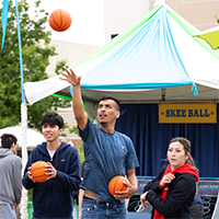 Students playing skee ball