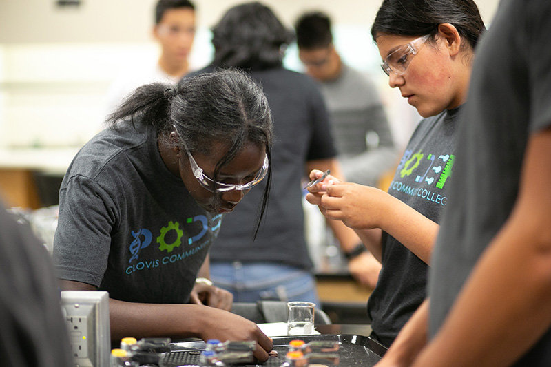 A female PODER student learning in the classroom