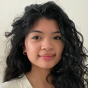 Cayleigh Stitchon, pictured with thick curly black hair against a white background