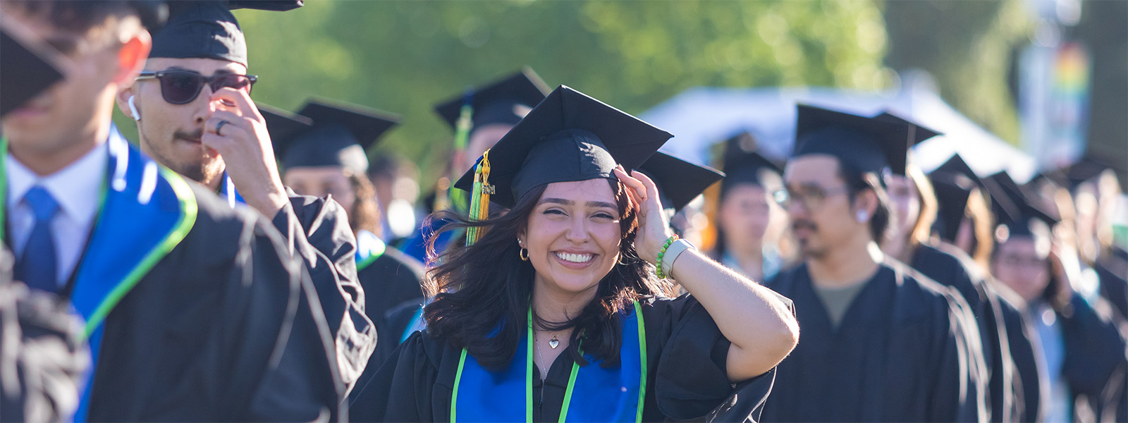 Students smiling, in their graduation gowns