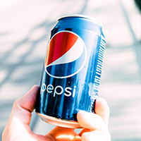 Person holding a Pepsi can (photo by Martin Pechy)
