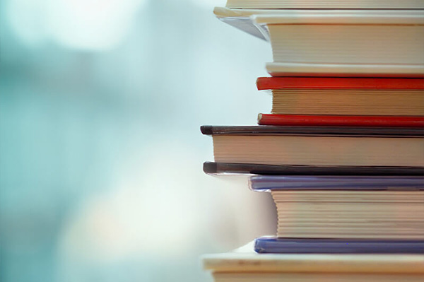 A graphic of a pile of school books