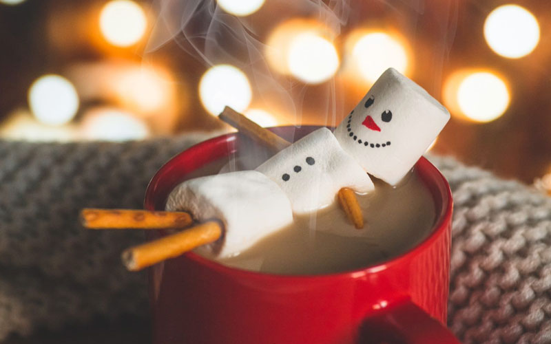 Marshmello snowman lying in hot coco