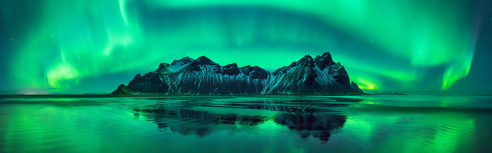 aurora borealis over a mountain