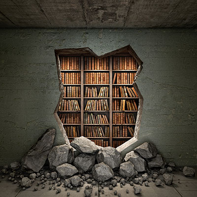 A hole broken through a wall showing books