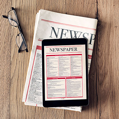 newspaper with tablet