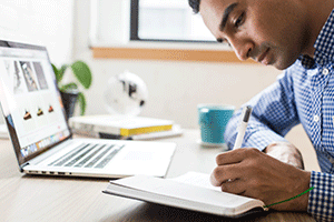 Student with computer and book