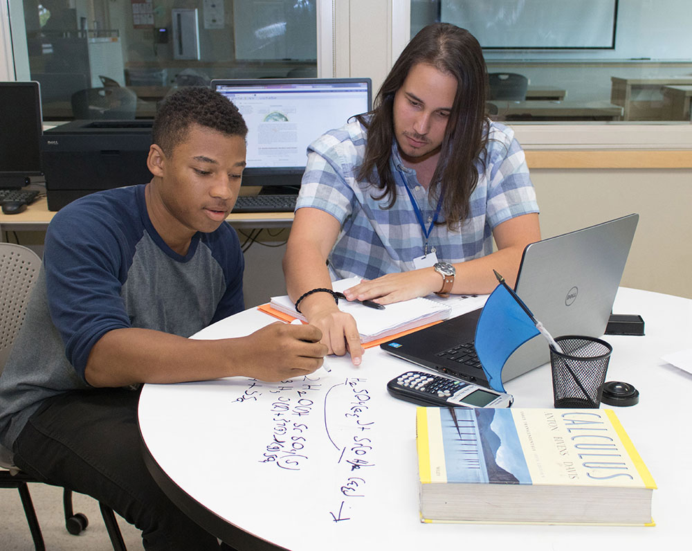 A tutor helps a student in the Tutorial Center