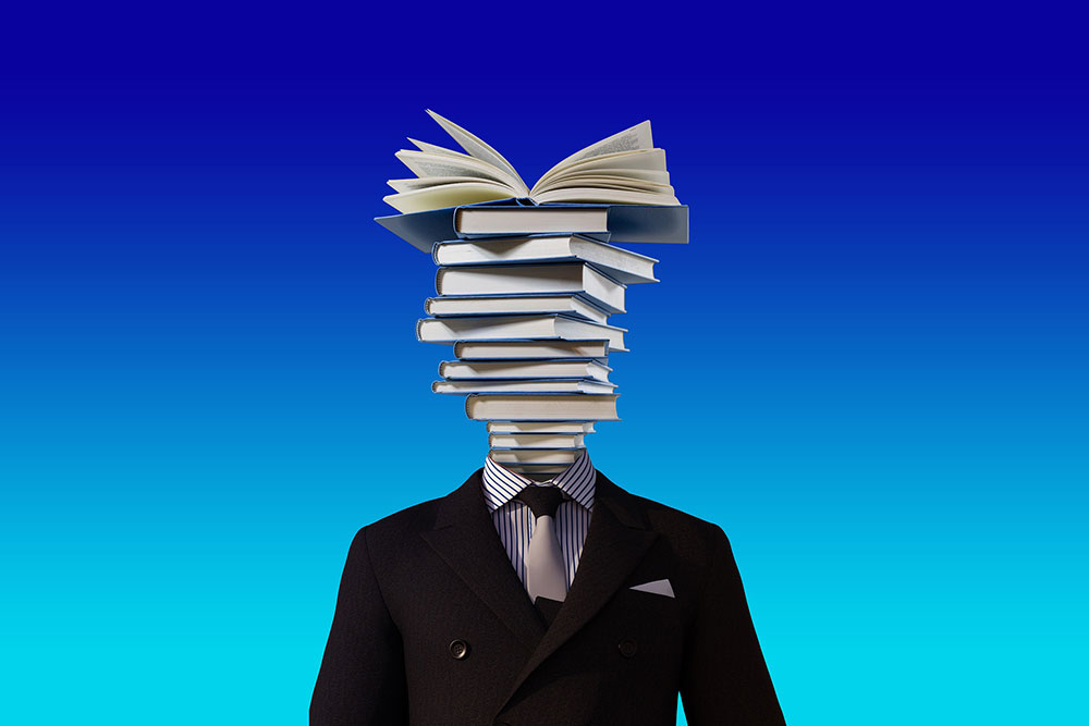 Man's body with books for his head